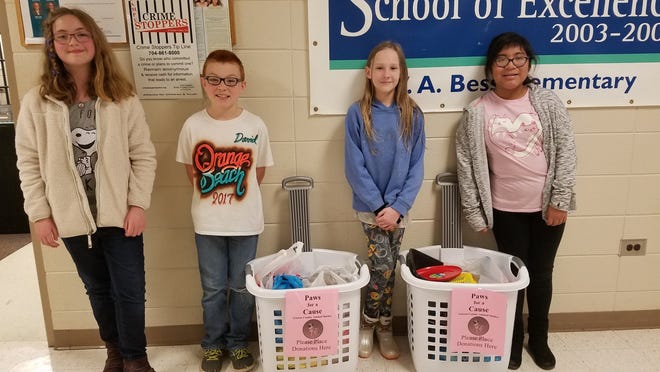Pictured, from left, Morgan Spivey, David King, Emma Costner, and Jessica Faux display some of the items collected for the Gaston County Animal Shelter. [PROVIDED PHOTO]