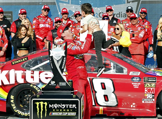 Kyle Busch celebrates Sunday's victory at ISM Raceway. [AP Photo/Ralph Freso]