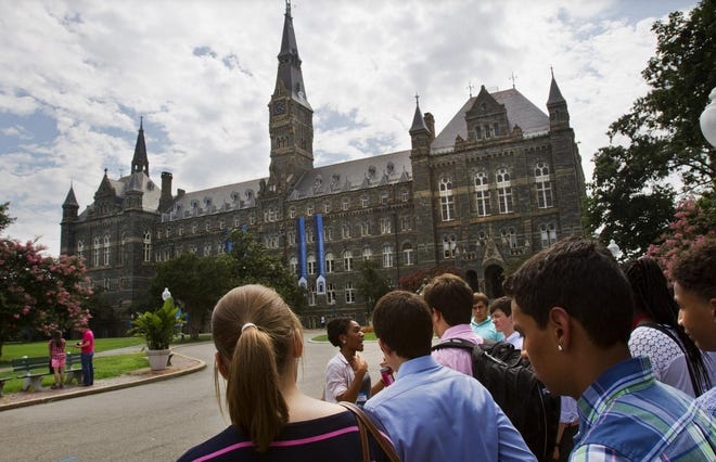 Prospective students tour Georgetown University. People linked to several well-known schools were accused Tuesday of taking bribes to ensure specific students were admitted. [JACQUELYN MARTIN/ASSOCIATED PRESS FILE PHOTO]