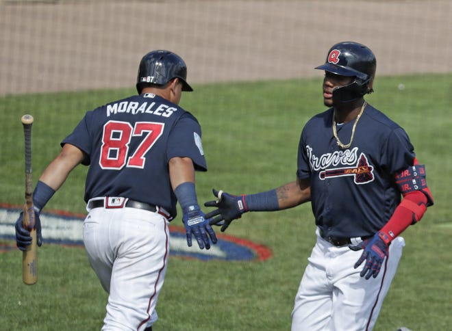 The Atlanta Braves' Jonathan Morales, left, congratulates teammate Ronald Acuna Jr. on his sixth inning home run against the Houston Astros in a spring exhibition game March 4 in Kissimmee, Fla. [JOHN RAOUX/THE ASSOCIATED PRESS]