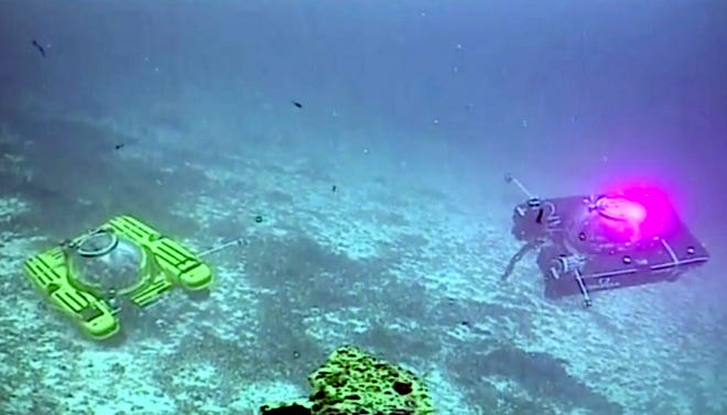 An image taken from video issued by Nekton shows two submersibles from the vessel the Ocean Zephyr during a descent into the Indian Ocean off Alphonse Atoll near the Seychelles, Tuesday March 12, 2019. Members of the British-led Nekton research team boarded two submersible vessels and descended into the waters off the Seychelles on Tuesday, marking a defining moment in their mission to document changes to the Indian Ocean. The submersibles will be battling strong undersea currents and potentially challenging weather conditions as they survey the side of an undersea mountain off Alphonse Atoll. (Nekton via AP)