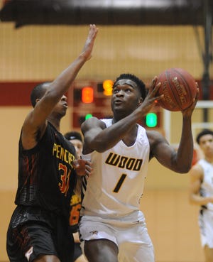 Archbishop Wood's Julius Phillips (1) drives to the basket as Penncrest's Malcolm Williams (31) defends in the first quarter of the Class 5A second round playoff game of Archbishop Wood against Penncrest. [WILLIAM THOMAS CAIN / CORRESPONDENT]