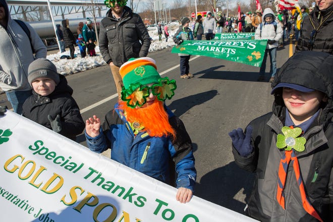 Six-year-olds Lucas Wojcicki, Mason Bennett, and Travis Velez, of Levittown, carry a banner during last year's Bucks County St. Patrick's Day Parade. [DAVE HERNANDEZ /FILE]