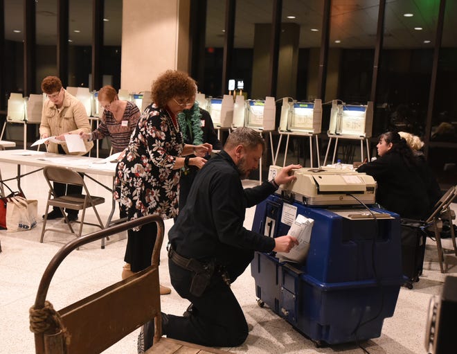 As the polls close, the ballots at Government Center are tended to, on recall election night, Tuesday, in Fall River. [Herald News Photo | Jack Foley]