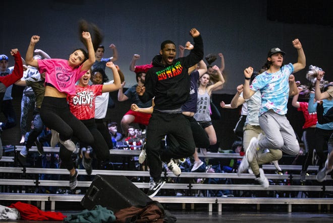 Glenwood High senior Rachael Dickenson, left, junior Marcus Lindsay, center, and senior Jake Mathis, right, join their fellow members of the Titan Fever show choir as they all hit their marks in sync during rehearsals at school last week as they prepare for the Show Choir Nationals in Nashville. [Justin L. Fowler/The State Journal-Register]