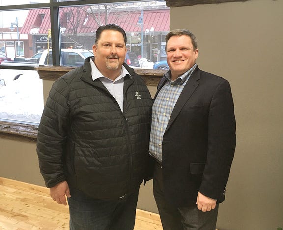 Moore Trosper President Ted Moore greets Sen. Wayne Schmidt (R-Traverse City) at the company’s new office in Sault Ste. Marie.