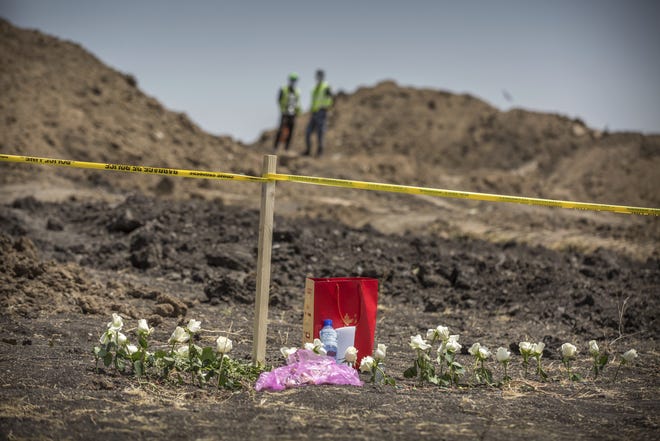 Flowers are left at the scene where the Ethiopian Airlines Boeing 737 Max 8 plane crashed shortly after takeoff on Sunday killing all 157 on board, near Bishoftu, south of Addis Ababa, in Ethiopia on Wednesday. The U.S. is issuing an emergency order Wednesday grounding all Boeing 737 Max 8 and Max 9 aircraft "effective immediately." [The Associated Press]