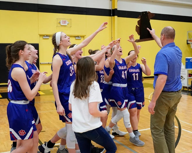 Lenawee Christian celebrates with the Division 4 regional championship trophy after beating Portland St. Patrick on Wednesday at Lansing Christian.