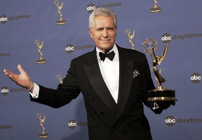 In this Friday, April 28, 2006, file photo, Alex Trebek holds the award for outstanding game show host, for his work on "Jeopardy!" backstage at the 33rd Annual Daytime Emmy Awards in Los Angeles. Canadian "Jeopardy!" host Trebek announced he's been diagnosed with advanced pancreatic cancer in a YouTube video on Wednesday, March 6, 2019, that had a positive tone despite the grim prognosis. (AP Photo/Reed Saxon, File)