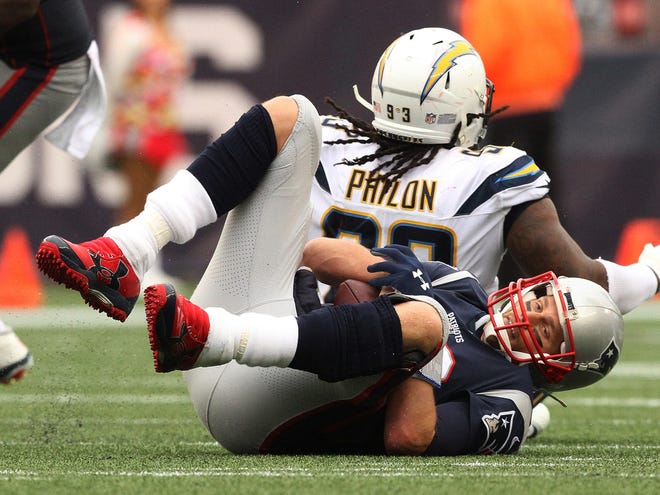 Patriots QB #12 Tom Brady is sacked by #93 Darius Philon of the Chargers.