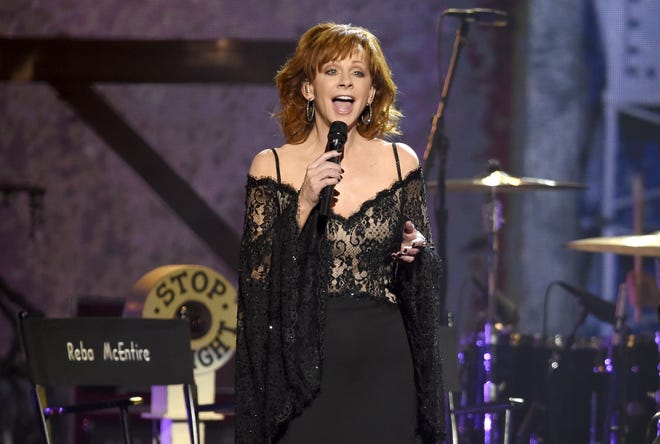 Reba McEntire performs "Legends" at the 51st annual CMA Awards at the Bridgestone Arena on Wednesday, Nov. 8, 2017, in Nashville, Tennessee. McEntire will appear at the Grandstand the final Sunday of the 2019 Illinois State Fair. [Chris Pizzello/Invision/AP]
