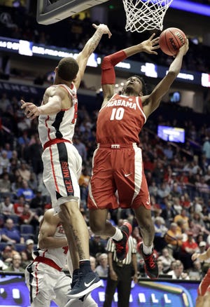 Alabama guard Herbert Jones (10) shoots against Mississippi forward KJ Buffen (14) in the first half of an NCAA college basketball game at the Southeastern Conference tournament Thursday, March 14, 2019, in Nashville, Tenn. (AP Photo/Mark Humphrey)