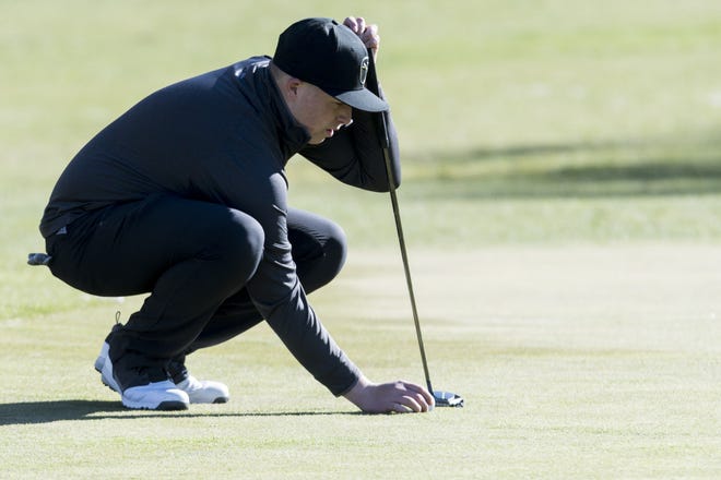 University Prep's Andrew Acosta lines up a putt on the eighth green Thursday during the Cross Valley League match at Hesperia Golf Club. [James Quigg, Daily Press]