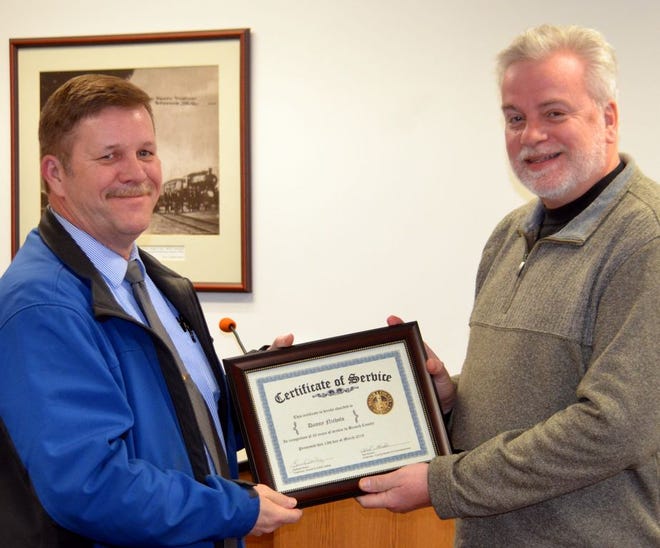 Branch County Commissioner Randall Hazelbaker presented a certificate of recognition to Sheriff Det/Sgt Dan Nichols for his 30 years of service with the Branch County Sheriff Department. Nichols took time to shake the hand of and thank Commission Chairman Ted Gordon, the former sheriff who hired him in 1988.