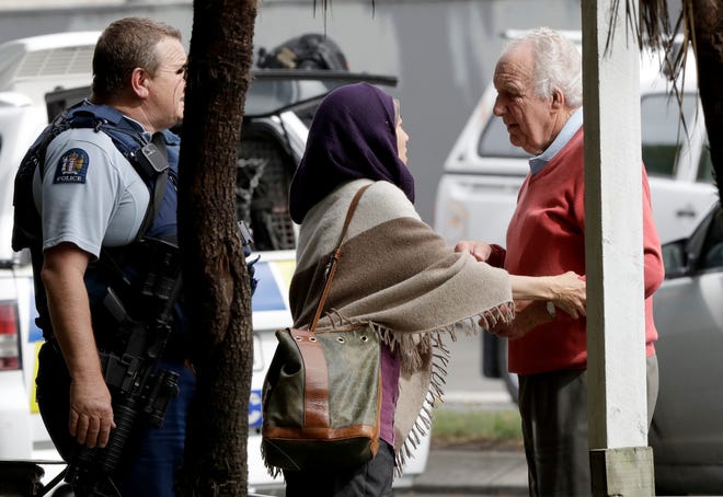 Police escort people away from outside a mosque in central Christchurch, New Zealand, Friday, March 15, 2019. Multiple people were killed in mass shootings at two mosques full of people attending Friday prayers, as New Zealand police warned people to stay indoors as they tried to determine if more than one gunman was involved. (AP Photo/Mark Baker)