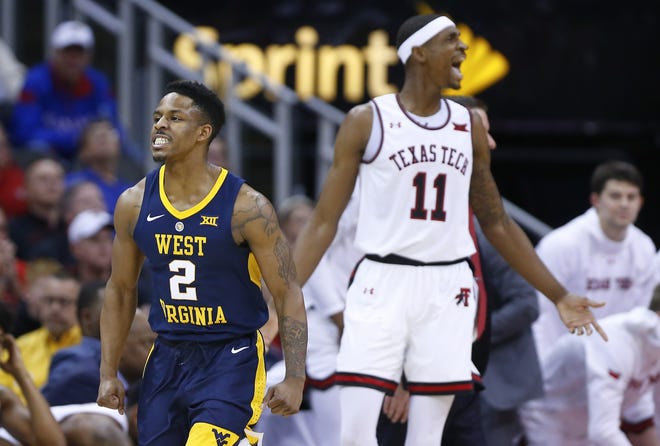 West Virginia guard Brandon Knapper (2) reacts after hitting a 3-pointer in front of Texas Tech forward Tariq Owens (11) during the first half of a quarterfinal round game Thursday in the Big 12 Tournament at the Sprint Center in Kansas City, Mo. The No. 7 Red Raiders suffered a 79-74 loss. [Chris Neal/The Capital-Journal]