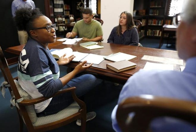 Morgan Peltier, a history major at the University of Florida, answers a question as she and a group of students doing an independent research project about the university's potential ties to slavery, talk with a reporter at UF's Smathers Library in Gainesville. [Brad McClenny / The Gainesville Sun]