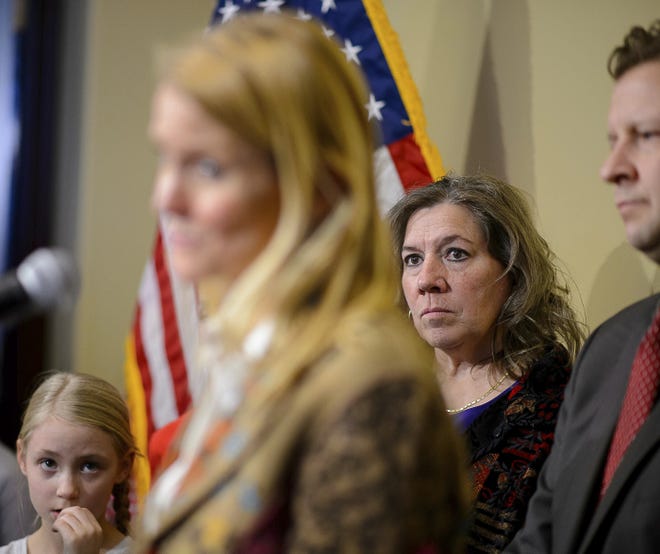 Valley View Elementary School teacher Moana Patterson, back right, listens as Tiffany Ivens-Spence speaks at a news conference by parents and students to show support for Patterson, in Salt Lake City, Monday, March 11, 2019. Ivens-Spence is the parent of a student at the school. Patterson, who is on administrative leave, apologized Monday for making 9-year-old Catholic student William McLeod wash off the Ash Wednesday cross from his forehead the week before, saying it was a misunderstanding. [Trent Nelson/The Salt Lake Tribune via AP]