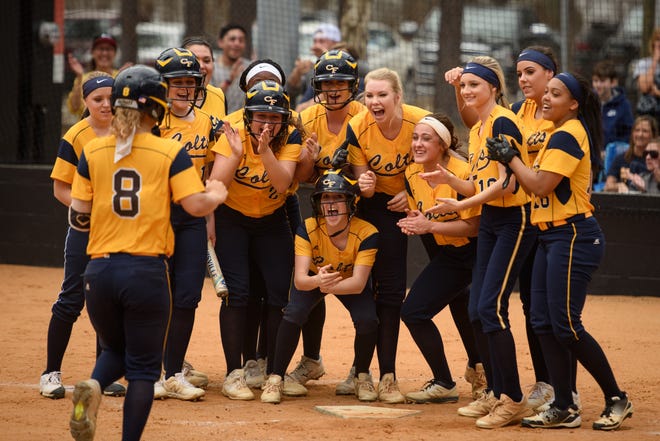 The Cape Fear team empties the dugout to cheer on teammate Jess Oxendine as she runs to home plate after hitting a home run against South View on Friday, March 15, 2019, at South View High School. [Andrew Craft/The Fayetteville Observer]