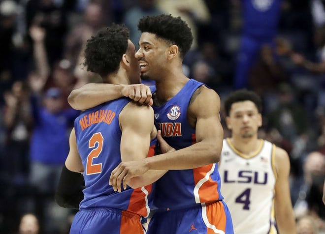 Florida guard Andrew Nembhard (2) is hugged by Jalen Hudson after Nembhard hit the winning 3-point basket against LSU in the second half of an NCAA college basketball game at the Southeastern Conference tournament Friday in Nashville, Tenn. [MARK HUMPHREY/AP PHOTO]