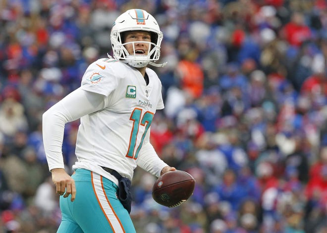 Miami Dolphins quarterback Ryan Tannehill (17) reacts after catching a pass for a touchdown thrown by Miami Dolphins wide receiver Kenny Stills (10) in the second quarter against the Buffalo Bills on Dec. 30, 2018, in Orchard Park, N.Y. [Al Diaz/Tribune News Service]