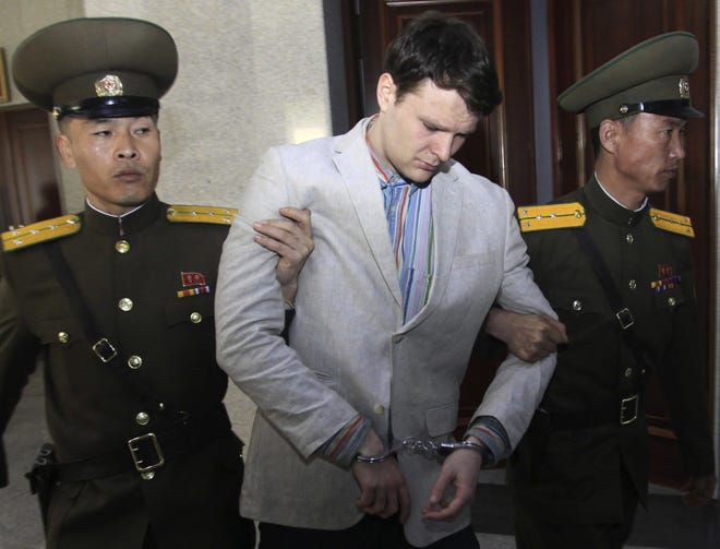 American student Otto Warmbier, center, is escorted at the Supreme Court on March 16, 2016, in Pyongyang, North Korea. Warmbier died in 2017 shortly after being sent home by North Korea in a coma. The Ohio native was sentenced to 15 years of hard labor in North Korea on suspicion of stealing a propaganda poster. [Jon Chol Jin/The Associated Press]