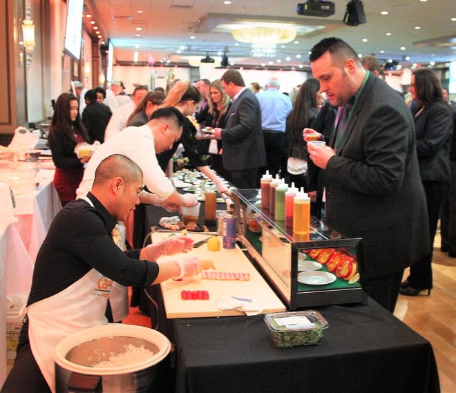 Fuji WOC owner Jimmy Liang and Ming Cao offer up sushi during the Taste of the South Shore event at Lombardo's in Randolph Fuji WOC owner Jimmy Liang and Ming Cao offer up sushi during the Taste of the South Shore event at Lombardo's in Randolph last year. [File photo/The Patriot Ledger]