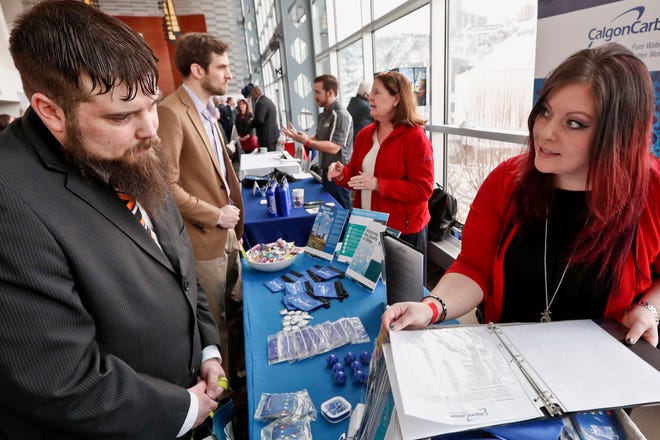 Visitors to the Pittsburgh veterans job fair meet with recruiters at Heinz Field on Thursday.