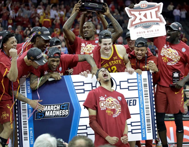 Iowa State players celebrate after their win over Kansas in Saturday's Big 12 tournament championship game. [Charlie Riedel/The Associated Press]