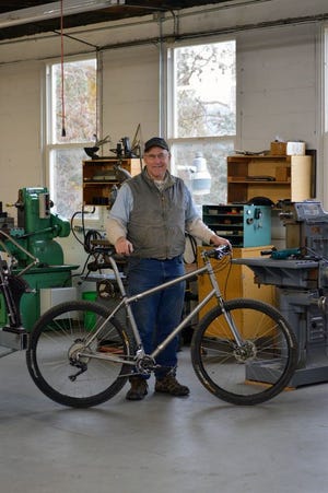 Etna’s Steve Potts stands with one of the custom bikes he makes for people all over the world.