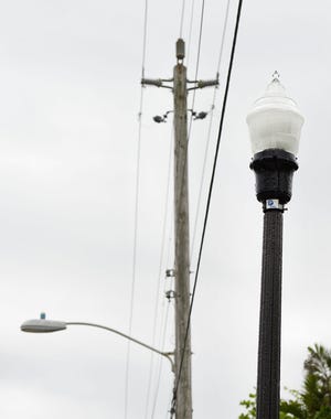 New light-emitting diode (LED) street lights, right, are shorter and brighter than the older halogen lights seen Friday along North Ocean Boulevard. [Meghan McCarthy/palmbeachdailynews.com]