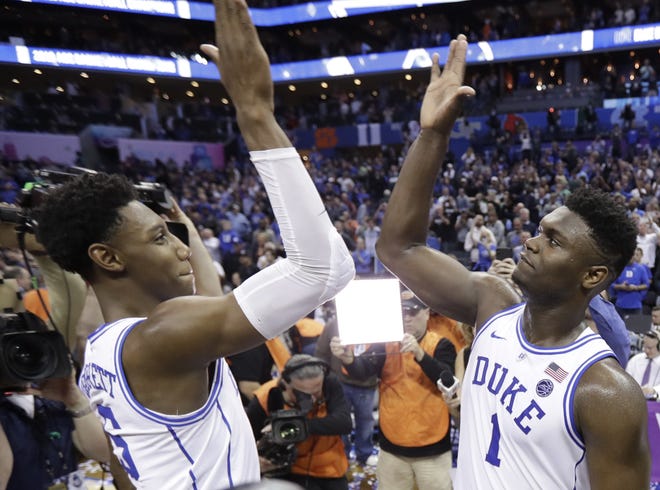 Duke's RJ Barrett (5) and Zion Williamson (1) celebrate after defeating Florida State in the championship game of the Atlantic Coast Conference tournament in Charlotte, N.C., Saturday. Duke was awarded the No. 1 seed for the NCAA Tournament on Sunday. [Photo by AP]