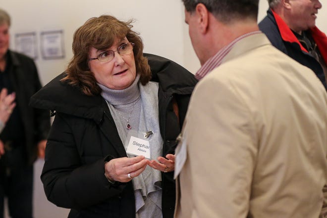 Stephanie Abisla, a candidate for Board of Library Trustees, speaks with other candidates before the Citizens for Milford annual candidates forum Thursday at St. Mary's Church. [Daily News and Wicked Local Photo / Dan Holmes]