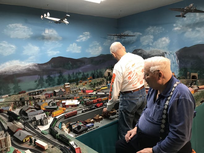 Juniper Village residents John Lahner, left, and Dick Moore enjoy the train room at the Bensalem continuing care retirement community that recently underwent a $10 million renovation. [CHRIS ENGLISH / STAFF]