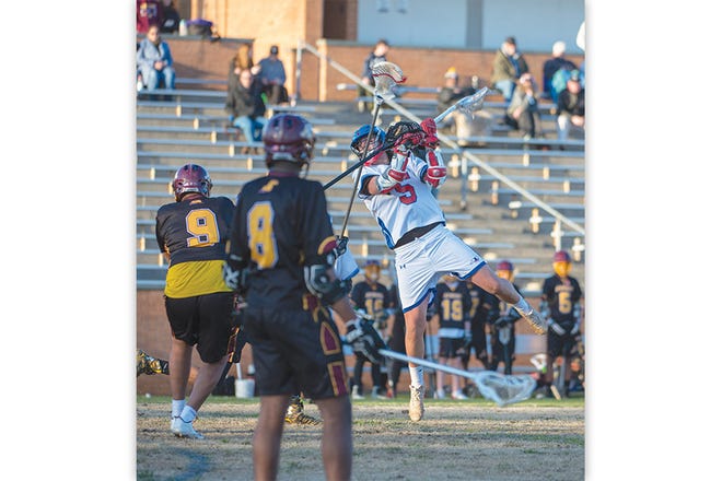 AHS' John Cernava (5) takes a shot during Monday's game, resulting in one of his seven goals