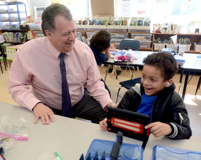 Wequonnoc Arts & Technology Magnet School's Principal Scott Fain visits with first grader Kendall Caceres-Flores 6, Monday morning. Fain will be retiring after the school year.

[Aaron Flaum/NorwichBulletin.com]