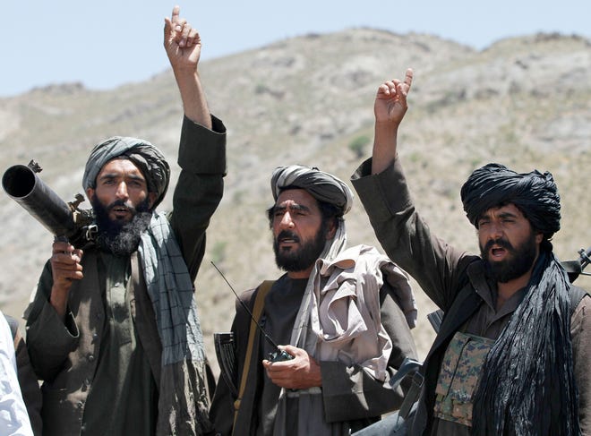 FILE - In this May 27, 2016 file photo, Taliban fighters react to a speech by their senior leader in the Shindand district of Herat province, Afghanistan. With U.S. support, the Afghan government has made a surprising new peace offer to the Taliban, only to immediately run into a wall. The insurgents show no sign of shifting from their demand that talks for a conflict-ending compromise take place with Washington, not Kabul. (AP Photos/Allauddin Khan, File)