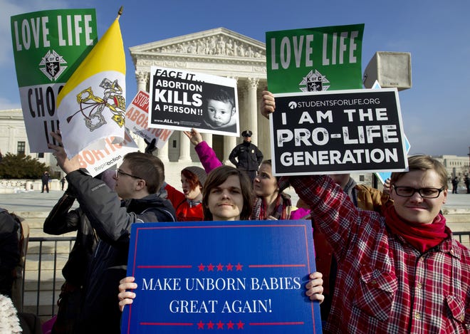 In this Jan. 18, photo, anti-abortion activists protest outside of the U.S. Supreme Court, during the March for Life in Washington. Under a bill that began moving forward Tuesday, Florida could block teenagers from getting abortions unless their parents agree. The legislation, if ultimately approved, could spark a lawsuit that could wind up before a revamped Florida Supreme Court. [Jose Luis Magana/AP Photo]