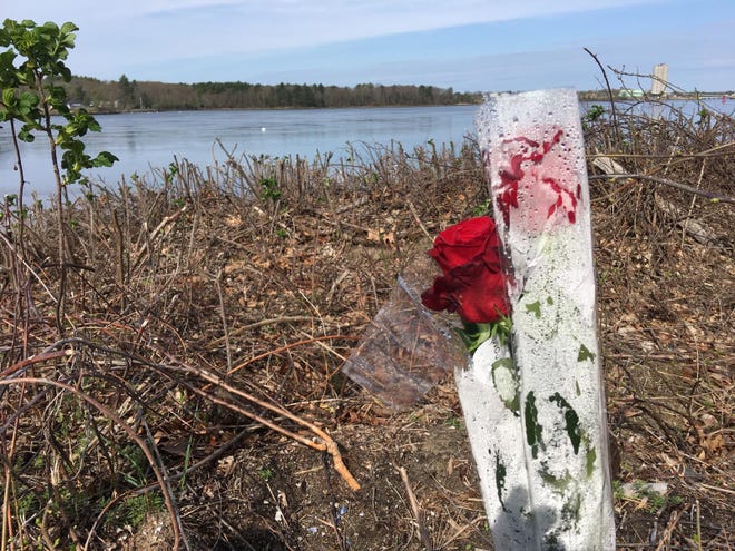 Two roses are placed at the boat launch in Eliot, Maine, in May 2018, following a boat crash that took the lives of 7-year-old Kaillen Wickman and Laurie Stewart, 56. [Deb Cram/Seacoastonline and Fosters.com, file]