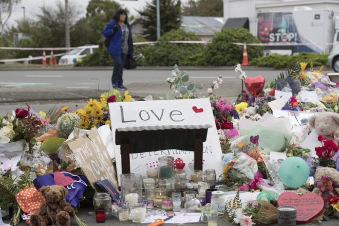 Flowers are placed for the victims of Friday's attack outside the Linwood mosque in Christchurch, New Zealand.[Vincent Thian/Associated Press]