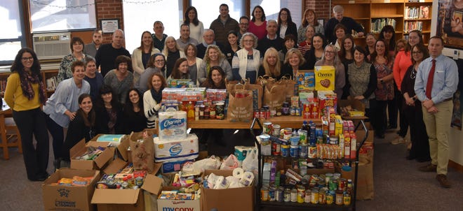 Tiverton High School faculty, staff and administrators recently took part in a food drive challenge that benefited the East Bay Community Action Program. [Submitted photo]