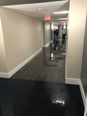 Water pooled in corridors at the Whitney after one fire sprinkler let loose. [Contributed]