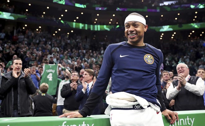 Denver Nuggets guard Isaiah Thomas smiles as his acknowledged by fans during a video tribute during a break the first quarter against the Boston Celtics in Boston, Monday. Thomas returned to play in his first game after being traded in 2017 for Kyrie Irving. [Charles Krupa/The Associated Press]