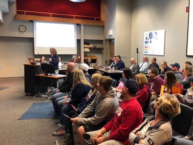 Gina Mentzer addresses the Seaman USD 345 school board Monday about the possibility of installing turf on the district's soccer field, as district soccer families and players listen. [Linda Ditch/Special to The Capital-Journal]