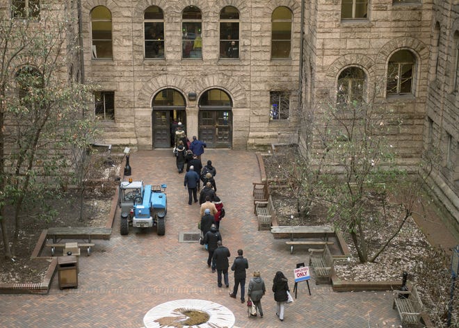 People arrive to the Allegheny County Courthouse prior to the start of the second day of the homicide trial of former East Pittsburgh police officer Michael Rosfeld on Wednesday in Pittsburgh. Rosfeld, 30, faces a charge of criminal homicide for the June 2018 death of 17-year-old unarmed black high school student Antwon Rose II. [Nate Smallwood/Pittsburgh Tribune-Review via AP]