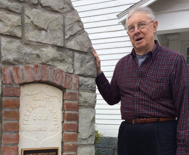 John Ourant, president of the Newcomerstown Historical Society, is pictured with a monument dedicated to Freeman Davis outside the Temperance Tavern Museum.