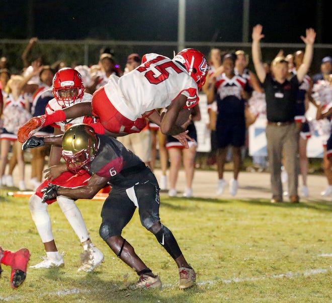 Vanguard's Trevonte Rucker (15) dives over North Marion's Jyron Gilmore into the end zone for a touchdown in the fourth quarter of the Knights' 20-14 win over the Colts at North Marion's Stan Toole Stadium in Sparr on Sept. 7. Vanguard and North Marion are now part of Class 5A, Region R2, District D6 which also includes Belleview, Dunnellon, and Lake Weir. [Doug Engle/Staff photographer/FILE]