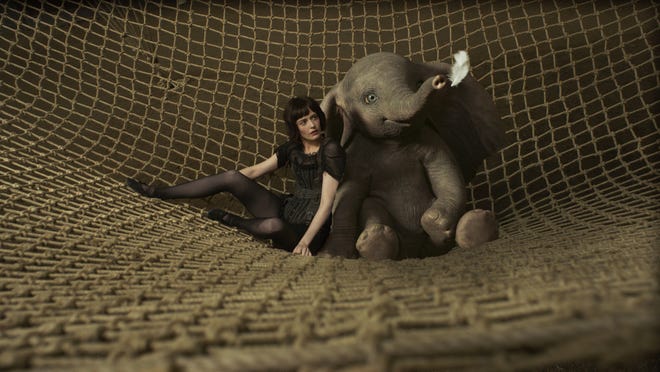 Colette (Eva Green) and her pachyderm co-star are equally fascinated by a white feather. [Walt Disney Studios]