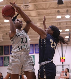 Shelton State forward Denetria Williams, guarded by Lawson State guard Rachel Davis, goes up for a shot during their game in February. Shelton State will play in the NJCAA national tournament, which starts Wednesday. [Photo/Joe Will Field]