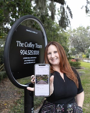 Janie Coffey of Compass is pictured with her firm's new high-tech "For Sale" signage. [CRAIG O'NEAL]